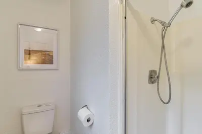 a bathroom with a white toilet and a shower at Less Than 1 Mi to Twain Harte Lake Forest-View Retreat! in Twain Harte