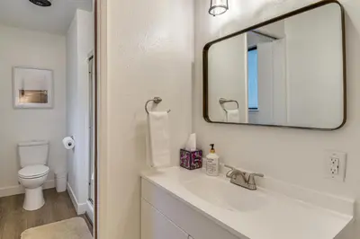 a white bathroom with a sink and a mirror at Less Than 1 Mi to Twain Harte Lake Forest-View Retreat! in Twain Harte