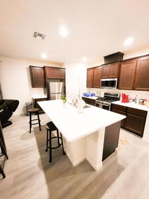a kitchen with a large white island in a room at Vip Class Two in Lodi
