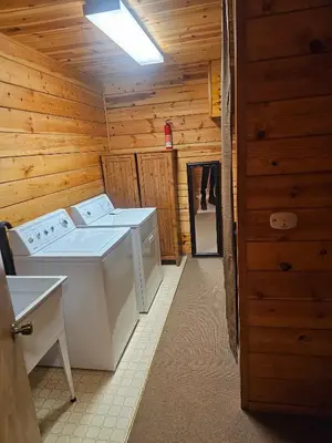 a bathroom with two washing machines in a cabin at The Cozy Knotty Pine Enchantment Retreat in Long Barn