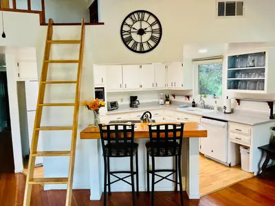 a kitchen with a large clock on the wall at Cozy Riverfront Home with EV charger in Three Rivers
