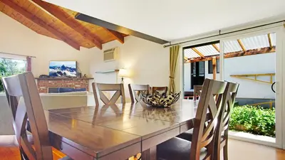 a dining room with a wooden table and chairs at Cozy Riverfront Home with EV charger in Three Rivers