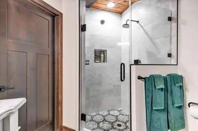 a bathroom with a shower with a glass door at Little Bridge Lodge Stateline - Small Dogs Ok in Stateline