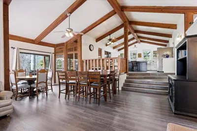 a kitchen and dining room with a table and chairs at Fun Getaway with Golf HotTub Volleyball and more in Oakhurst