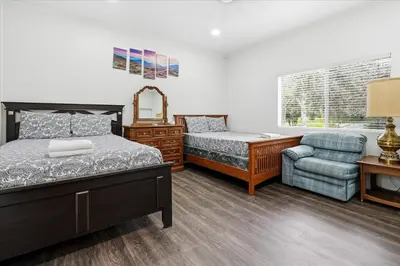 a bedroom with a bed and a desk and a chair at Fun Getaway with Golf HotTub Volleyball and more in Oakhurst
