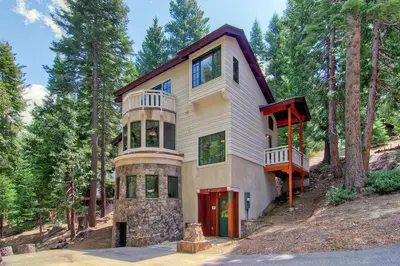 a house on a hill in the woods at Ahwahnichi Lodge in Yosemite West