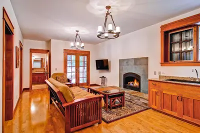 a living room with a couch and a fireplace at Ahwahnichi Lodge in Yosemite West