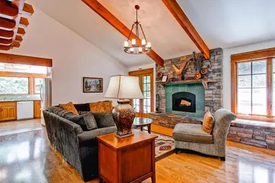 a living room with a couch and a fireplace at Ahwahnichi Lodge in Yosemite West