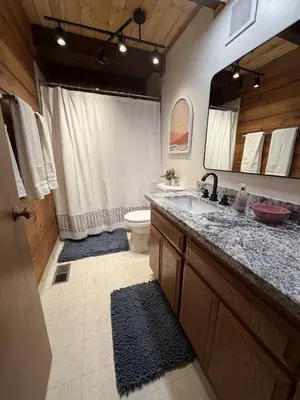 a bathroom with a sink and a toilet and a mirror at Three Bears Getaway Tahoe in Kings Beach