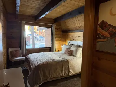 a bedroom with a bed in a room with a window at Three Bears Getaway Tahoe in Kings Beach