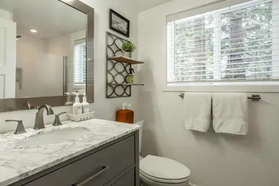 a bathroom with a sink and a toilet and a window at Luxury Helios Retreat by the Village- Apres Ready in Mammoth Lakes