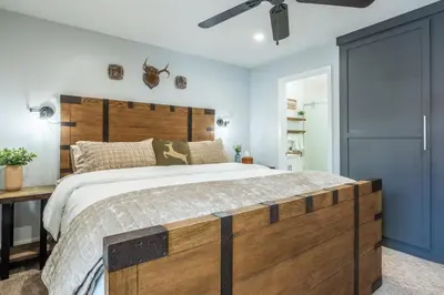 a bedroom with a large bed with a wooden headboard at Luxury Helios Retreat by the Village- Apres Ready in Mammoth Lakes