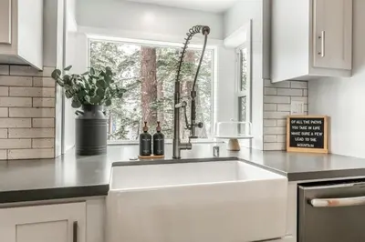 a kitchen with a white sink and a window at Luxury Helios Retreat by the Village- Apres Ready in Mammoth Lakes