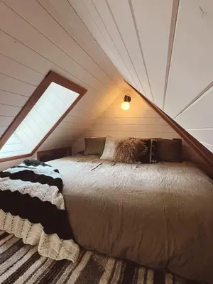 a bedroom with a large bed in a attic at Campo Carnelian in Carnelian Bay