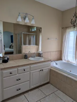 a bathroom with a tub and a sink and a bath tub at Quiet Murphys getaway steps away from 25+ wineries in Murphys