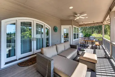 a screened in porch with a couch and a table at Quiet Murphys getaway steps away from 25+ wineries in Murphys
