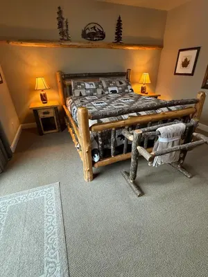 a bedroom with a bed with a wooden frame at Yosemite's Inn the Woods in Ahwahnee