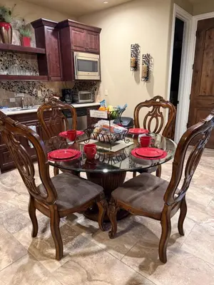 a kitchen with a table and chairs and a microwave at Yosemite's Inn the Woods in Ahwahnee
