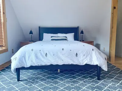 a blue bed with a white comforter with black stars at Stay at Whispering Pines, only 25 mi to Yosemite! in Midpines