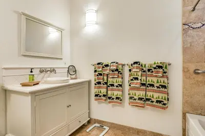 a bathroom with a sink and a shower curtain at Game Room and Hot Tub! Dog-Friendly Arnold Retreat in Arnold
