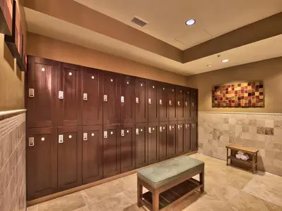 a locker room with wooden lockers and a bench at Northstar Ritz-Carlton in Truckee