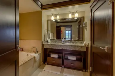 a bathroom with a tub and a sink and a mirror at Northstar Ritz-Carlton in Truckee