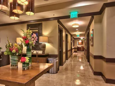 a hallway of a hospital with flowers on a table at Northstar Ritz-Carlton in Truckee