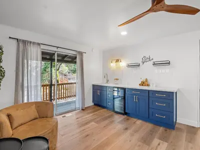 a living room with blue cabinets and a couch at Forest Retreat that accommodates 29 people near Yosemite & Bass Lake in Oakhurst