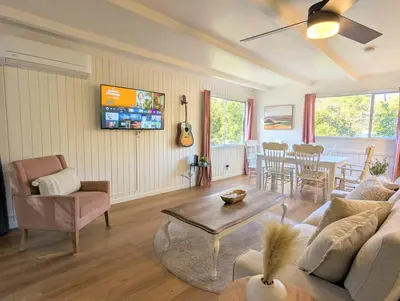 a living room with a couch and a table at Forest Retreat that accommodates 29 people near Yosemite & Bass Lake in Oakhurst
