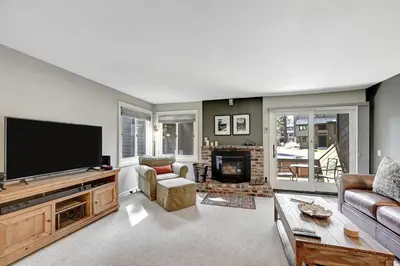 a living room with a large flat screen tv at Mountain Condo | Spa Pool and Ski Shuttle Access in Mammoth Lakes
