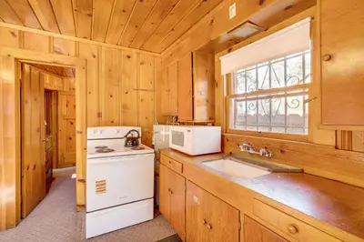 a kitchen with a white stove and a sink at Close to Lake and Heavenly Mtn Resort! Quaint Cabin in South Lake Tahoe