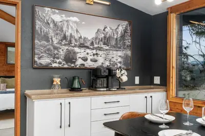 a kitchen with a table and a picture on the wall at New! Stunning views Hot tub King beds in Oakhurst