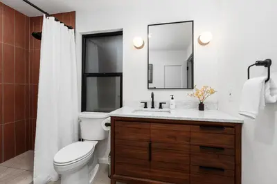 a bathroom with a toilet and a sink and a mirror at New! Stunning views Hot tub King beds in Oakhurst