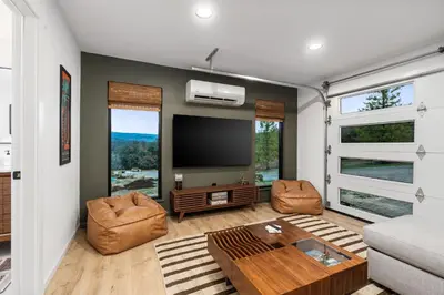 a living room with a flat screen tv and a couch at New! Stunning views Hot tub King beds in Oakhurst
