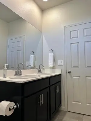 a bathroom with a sink and a large mirror at Prime Location Residence in Manteca