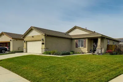 a house with a green lawn in front of it at Sophisticated Sanctuary 8 Mi to Lodi Wineries! in Stockton