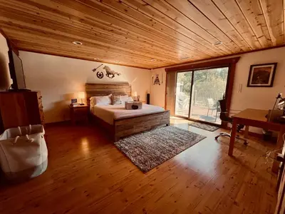 a bedroom with a bed and a wooden ceiling at Vista Chalet near Yosemite and Bass Lake in Oakhurst