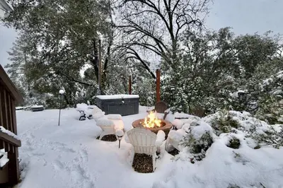 a fire pit in a yard covered in snow at Vista Chalet near Yosemite and Bass Lake in Oakhurst