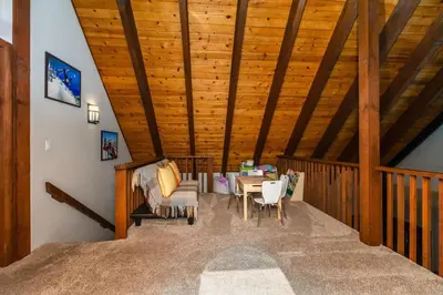 a room with a wooden ceiling with a table and chairs at Alder Creek Paradise Tree-lined Cabin Stay for 7 in Truckee