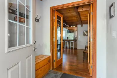a door leading into a dining room and kitchen at Alder Creek Paradise Tree-lined Cabin Stay for 7 in Truckee