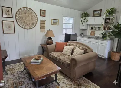 a living room with a couch and a coffee table at La Lomas Bohemian Courtyard Cottage in Modesto