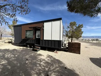 a black and white tiny house in the desert at Stylish Modern Tiny House on Wheels with Stunning Mountain Views Near Lone Pine, California in Lone Pine