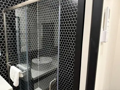 a shower stall with a toilet in a bathroom at Stylish Modern Tiny House on Wheels with Stunning Mountain Views Near Lone Pine, California in Lone Pine