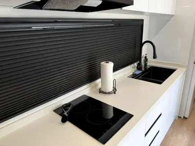 a kitchen counter with a sink and a window at Stylish Modern Tiny House on Wheels with Stunning Mountain Views Near Lone Pine, California in Lone Pine