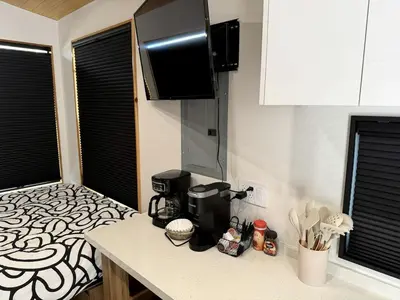 a kitchen with a coffee maker on a counter at Stylish Modern Tiny House on Wheels with Stunning Mountain Views Near Lone Pine, California in Lone Pine