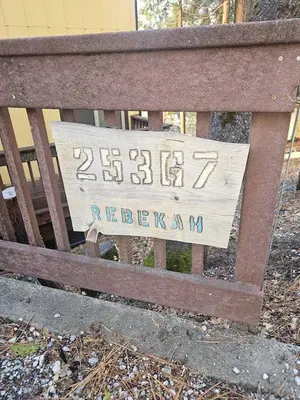 a wooden bench with a sign on the back of it at Peaceful Mountain Cabin with Private Lake and Game Room Near Long Barn, California in Long Barn