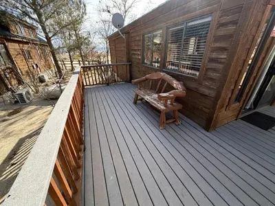 a wooden deck with a bench on a house at Cozy Mountain-Style Cabin with Scenic Sierra Nevada Views Near Lone Pine, California in Lone Pine