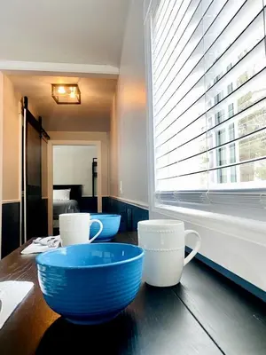two blue bowls on a wooden table with a window at Modern Tiny Home with Mountain Views Near Mt. Whitney, Lone Pine, California in Lone Pine