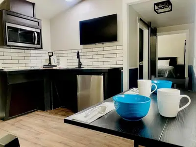 a kitchen with blue bowls on a black counter at Modern Tiny Home with Mountain Views Near Mt. Whitney, Lone Pine, California in Lone Pine