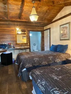 a bedroom with two beds and a mirror at St Annas House in Squaw Valley